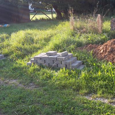 a hundred stem wall stones and a mound of clay soil